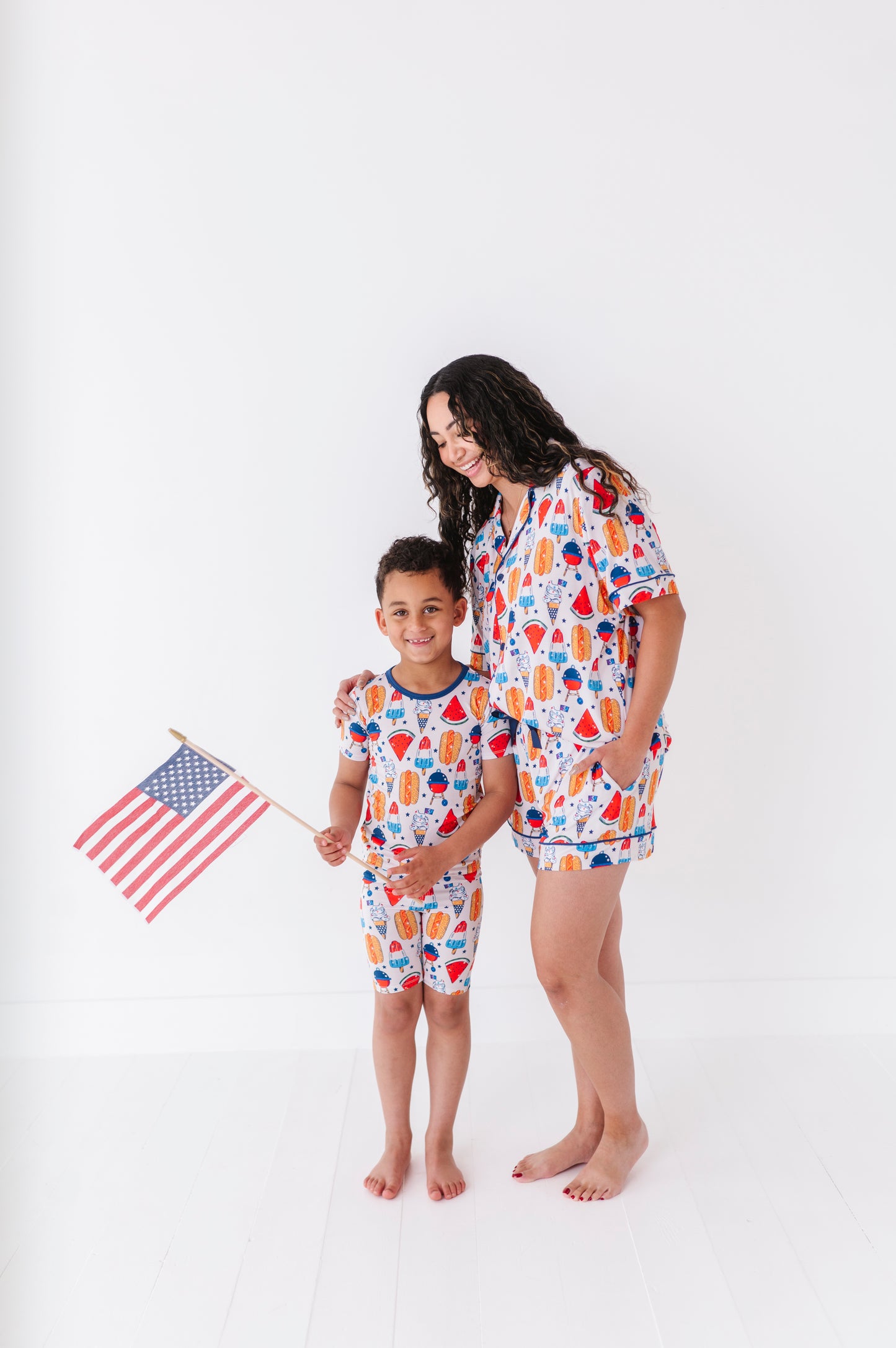 Mom wearing 4th of July hot dog pajamas made from soft bamboo fabric, perfect for matching family sets