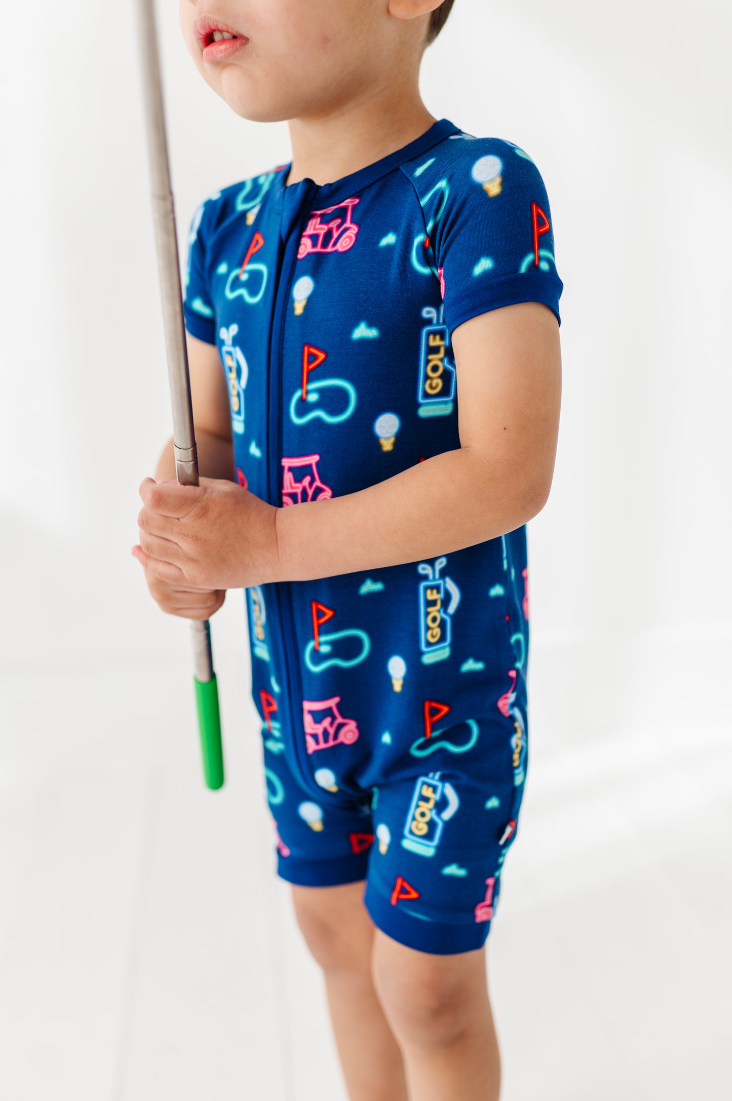 Boy In Neon Golf Shorties