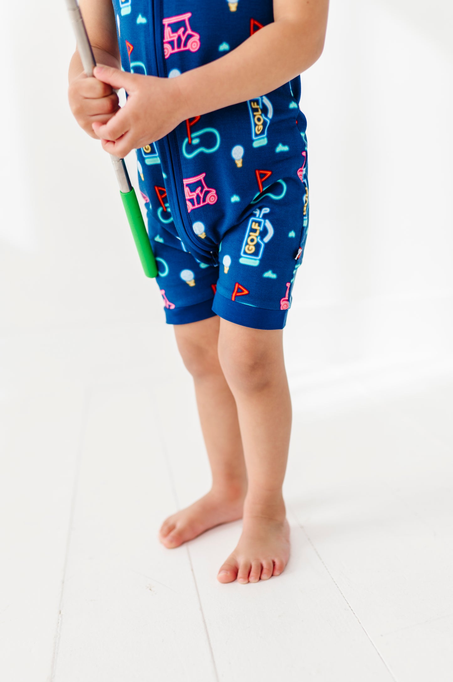 Boy In Neon Golf Shorties