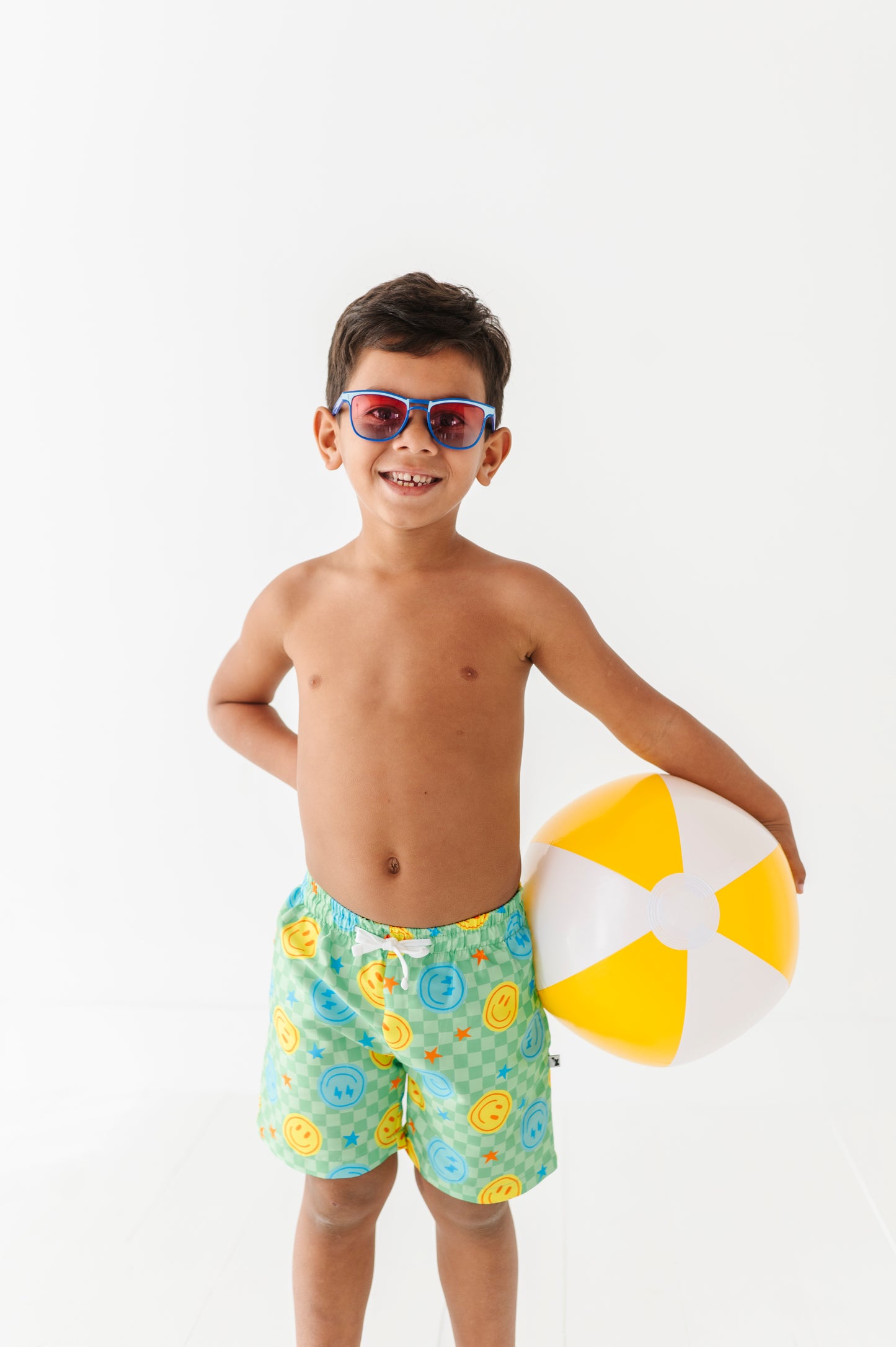 Boy rocking Neon Smiley Swim Shorts