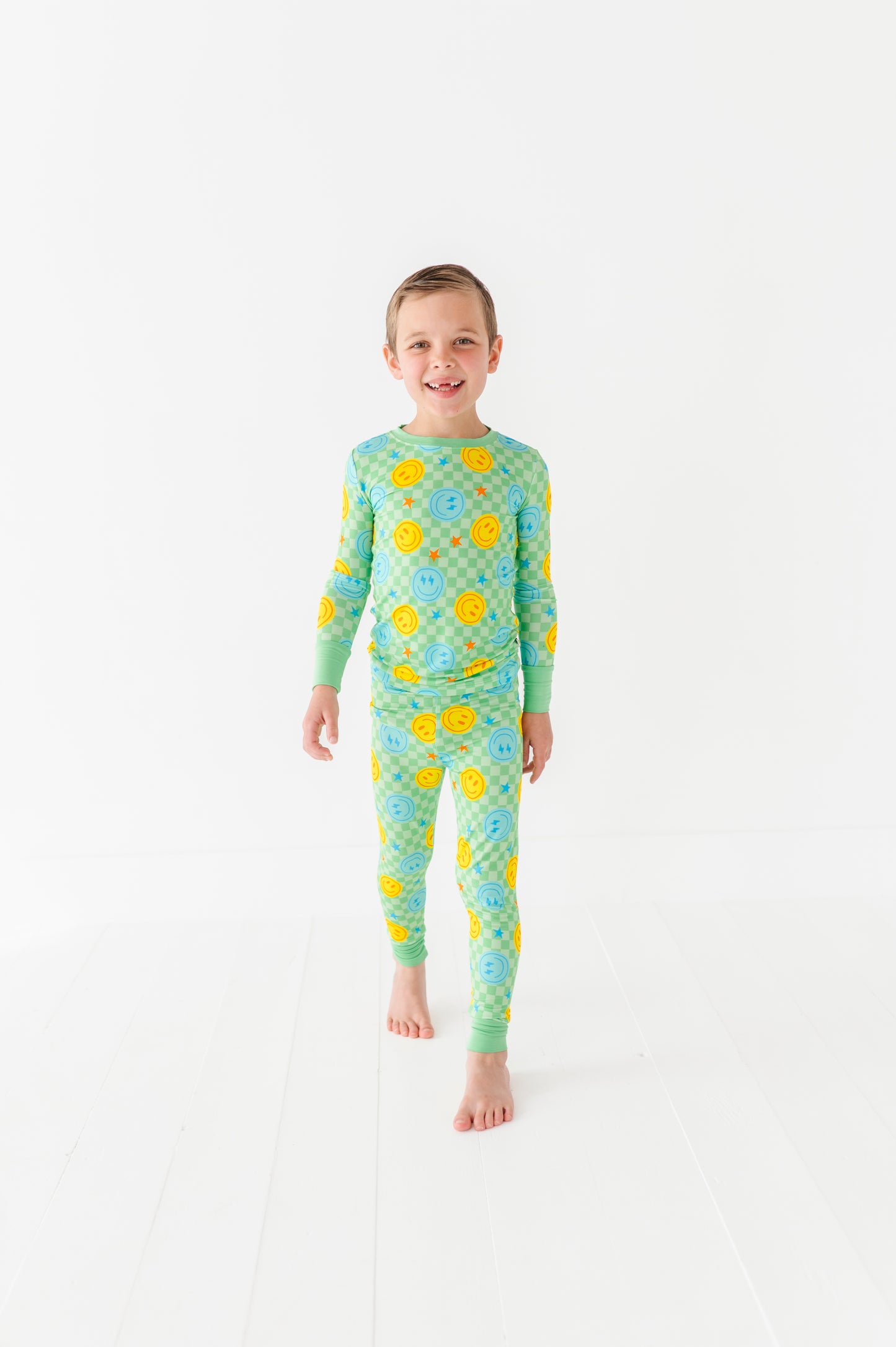 Boy wearing neon smiley pajamas