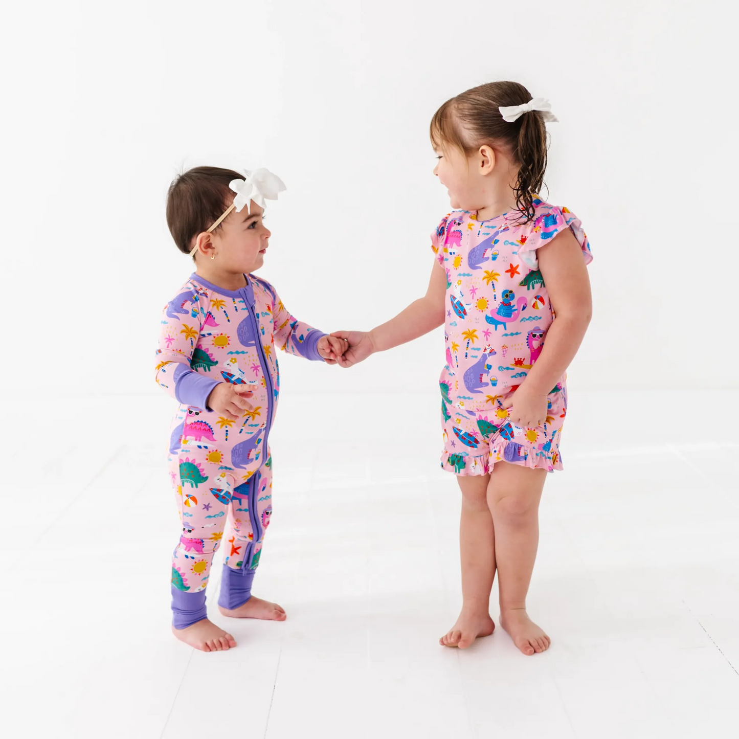 Girl in short pajama dinosaur set by Kiki and Lulu