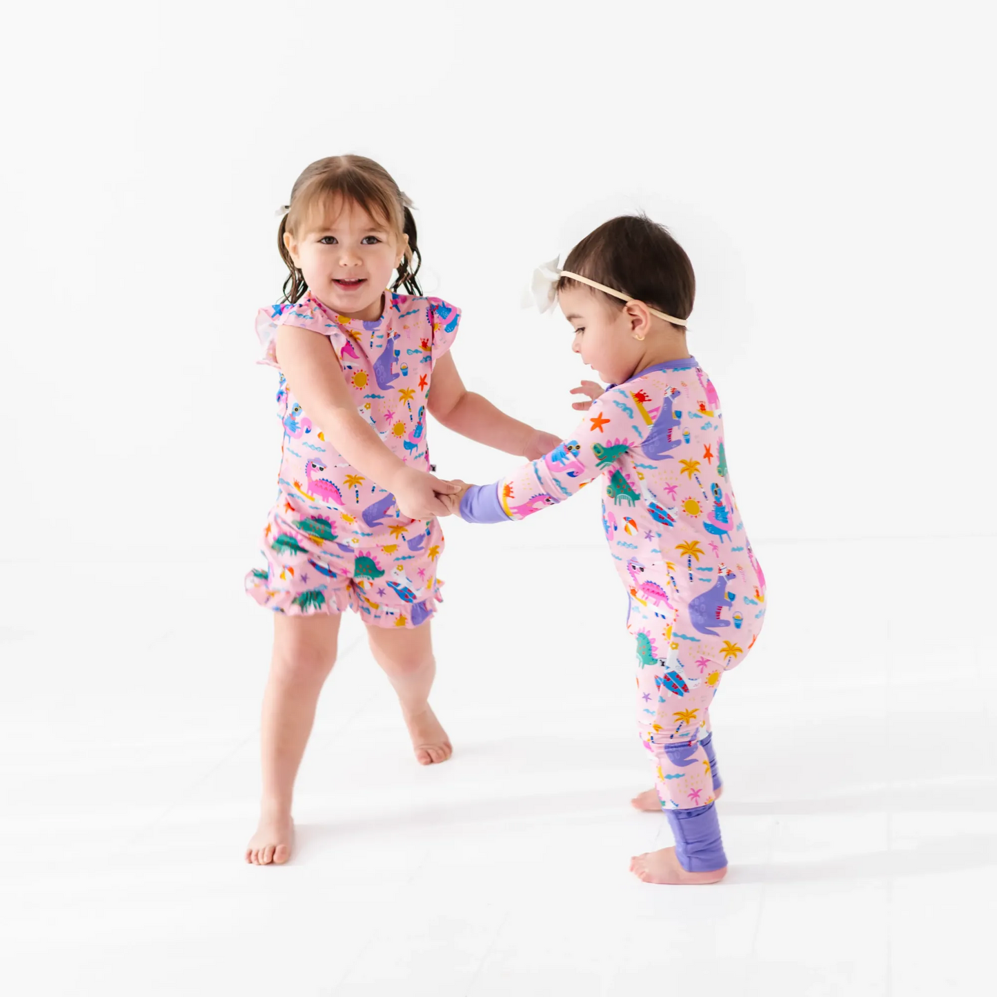 Girl in short pajama dinosaur set by Kiki and Lulu