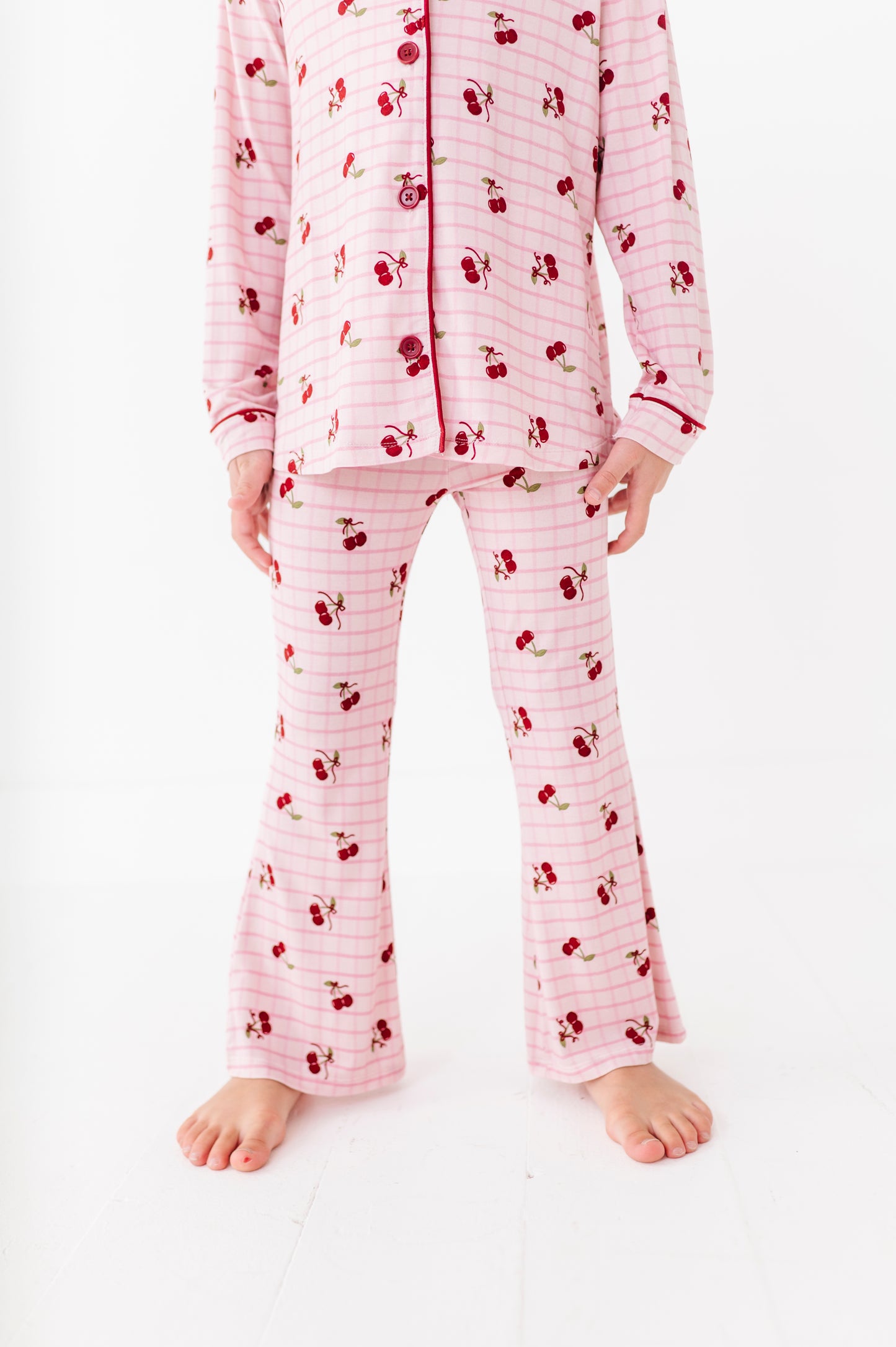 Pink pajama set with cherry pattern on a white background
