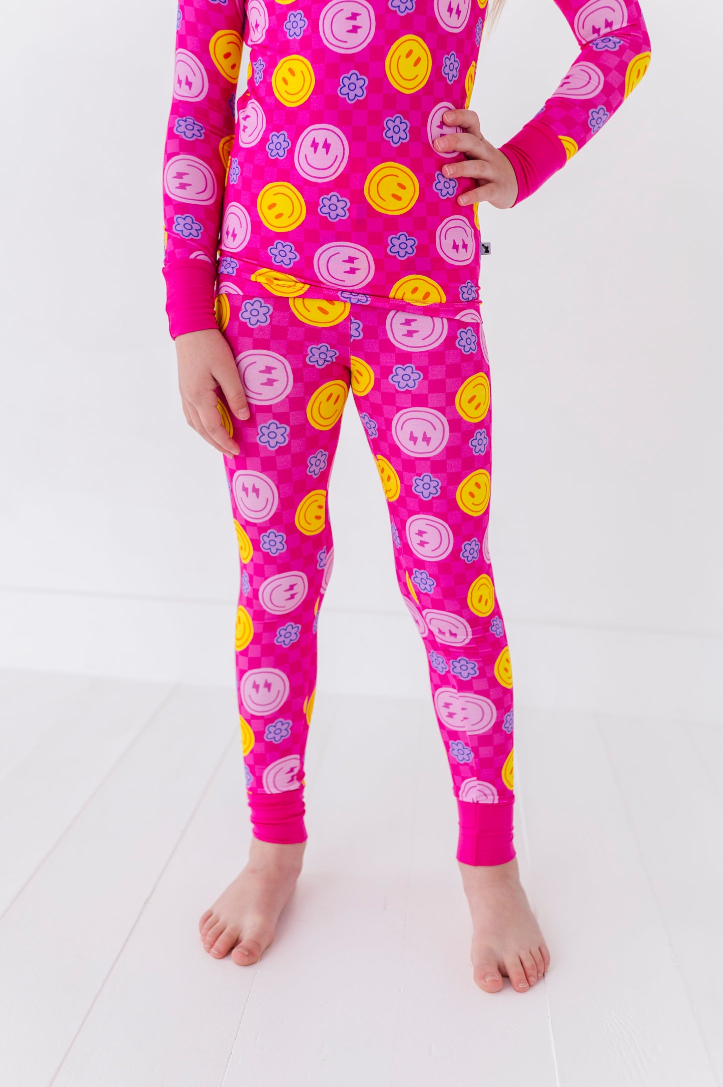 Girl in neon smiley pajamas