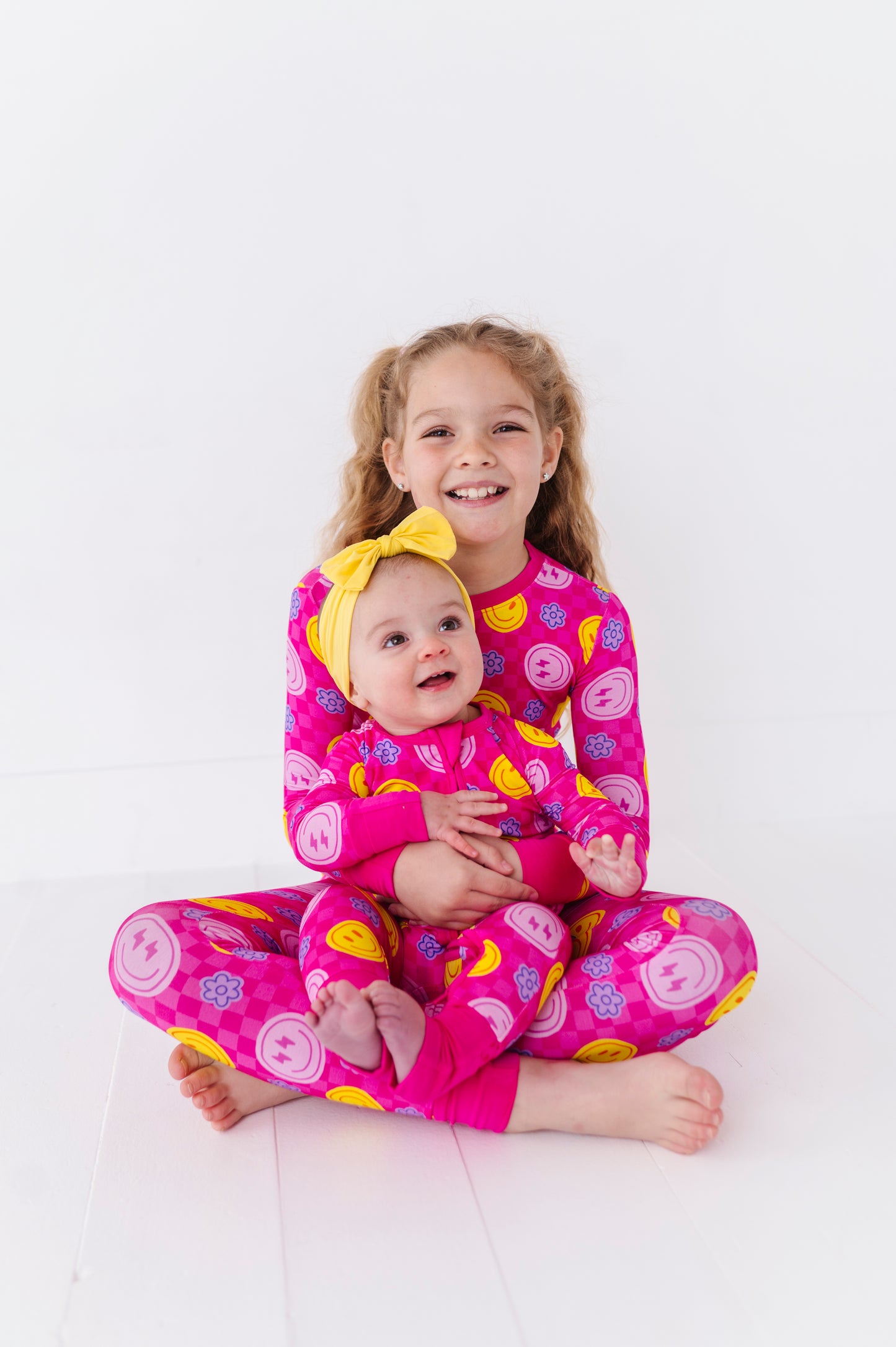 Kids in Matching neon smiley pajamas