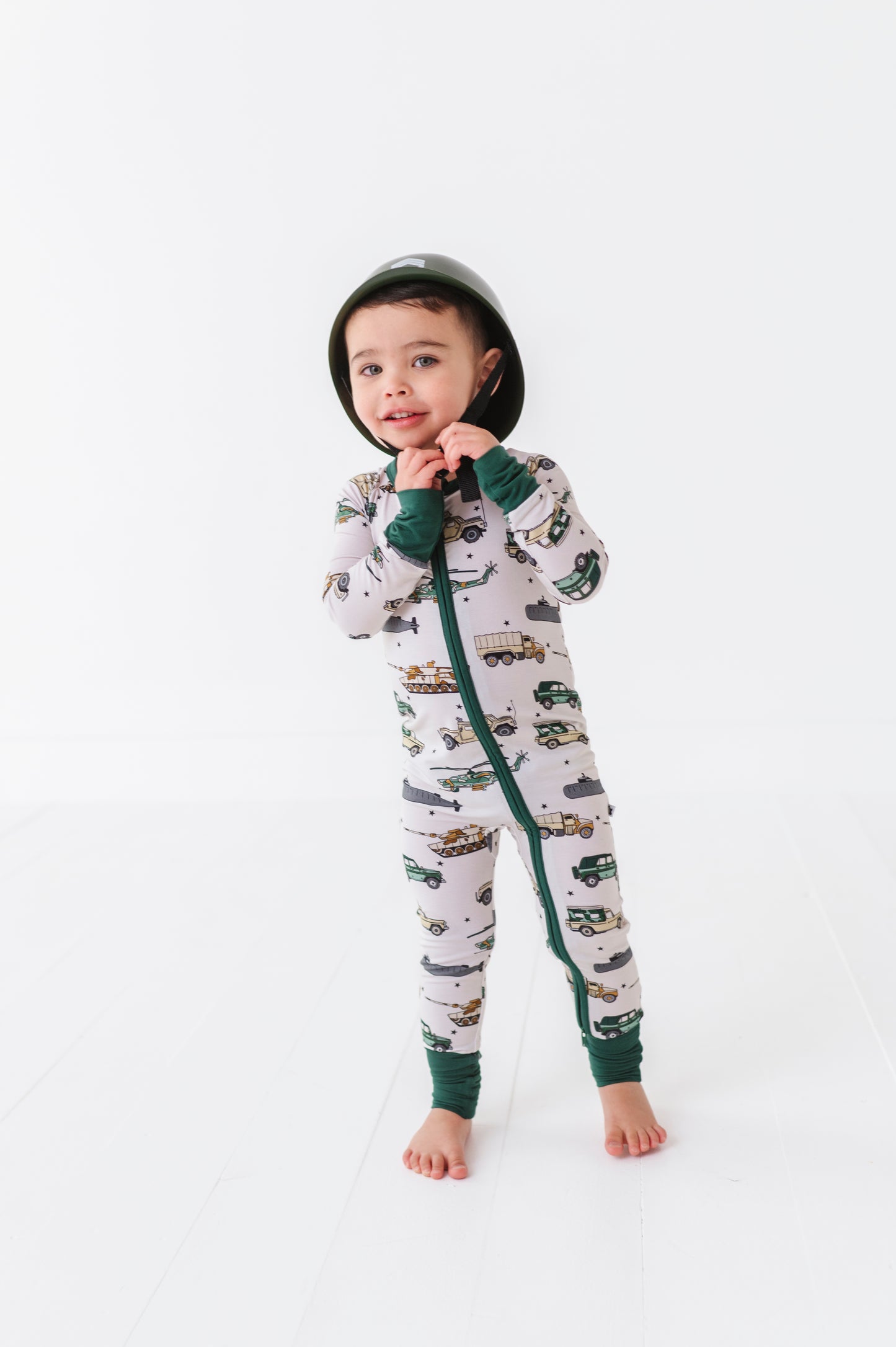 Boy wearing Military Vehicle Zip Pajamas