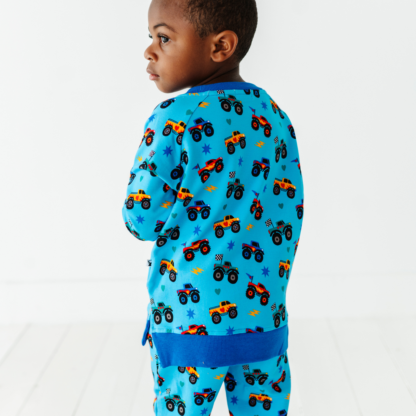 Kid wearing monster truck jogger set by Kiki and Lulu