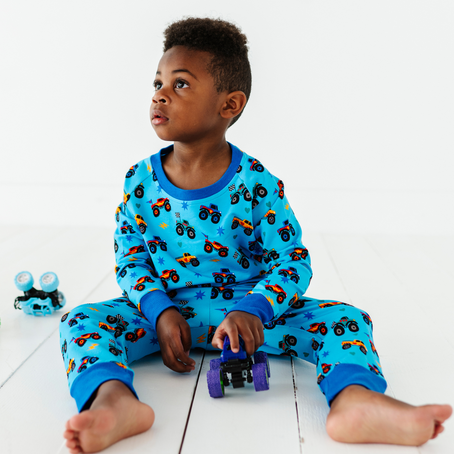 Kid wearing monster truck jogger set by Kiki and Lulu