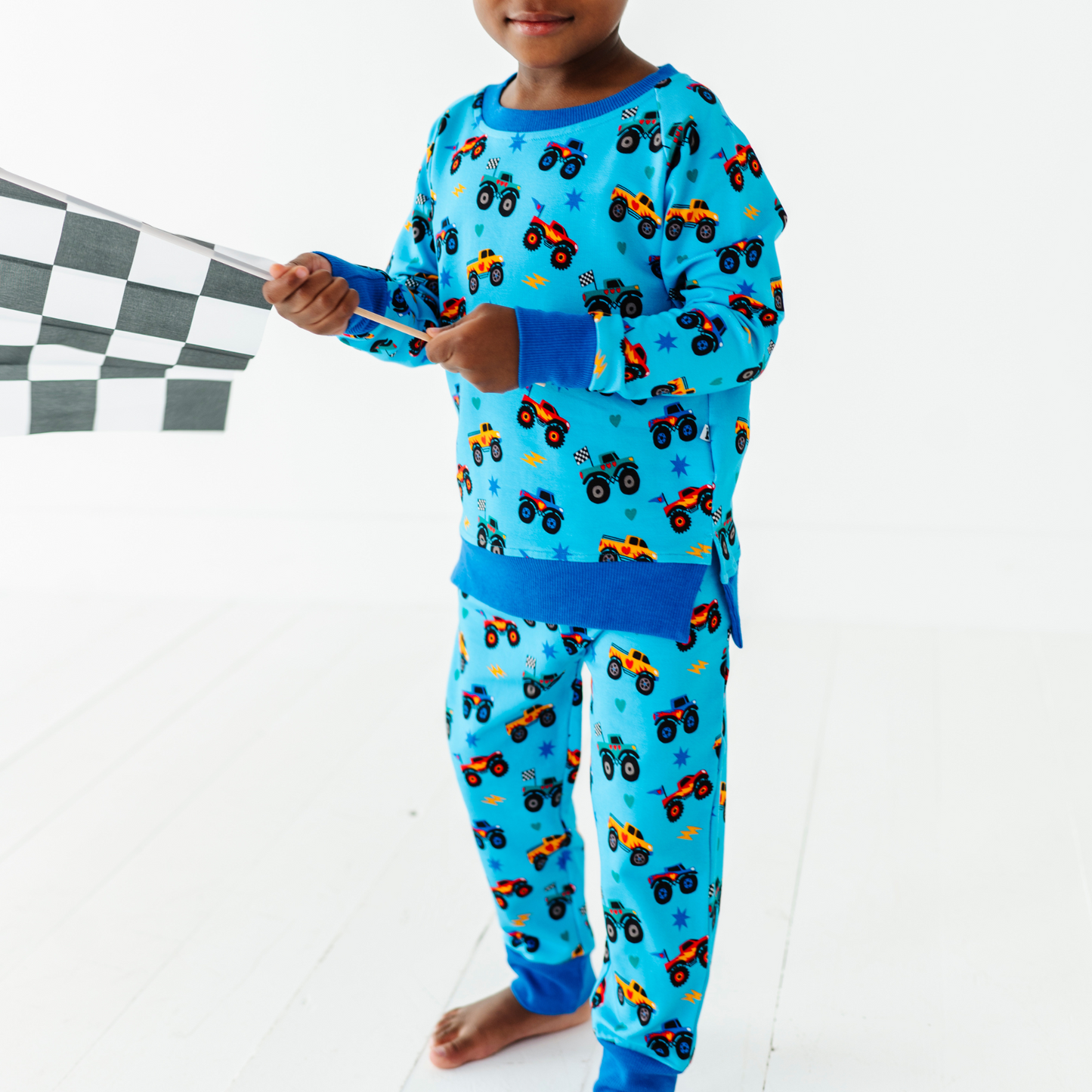 Kid wearing monster truck jogger set by Kiki and Lulu