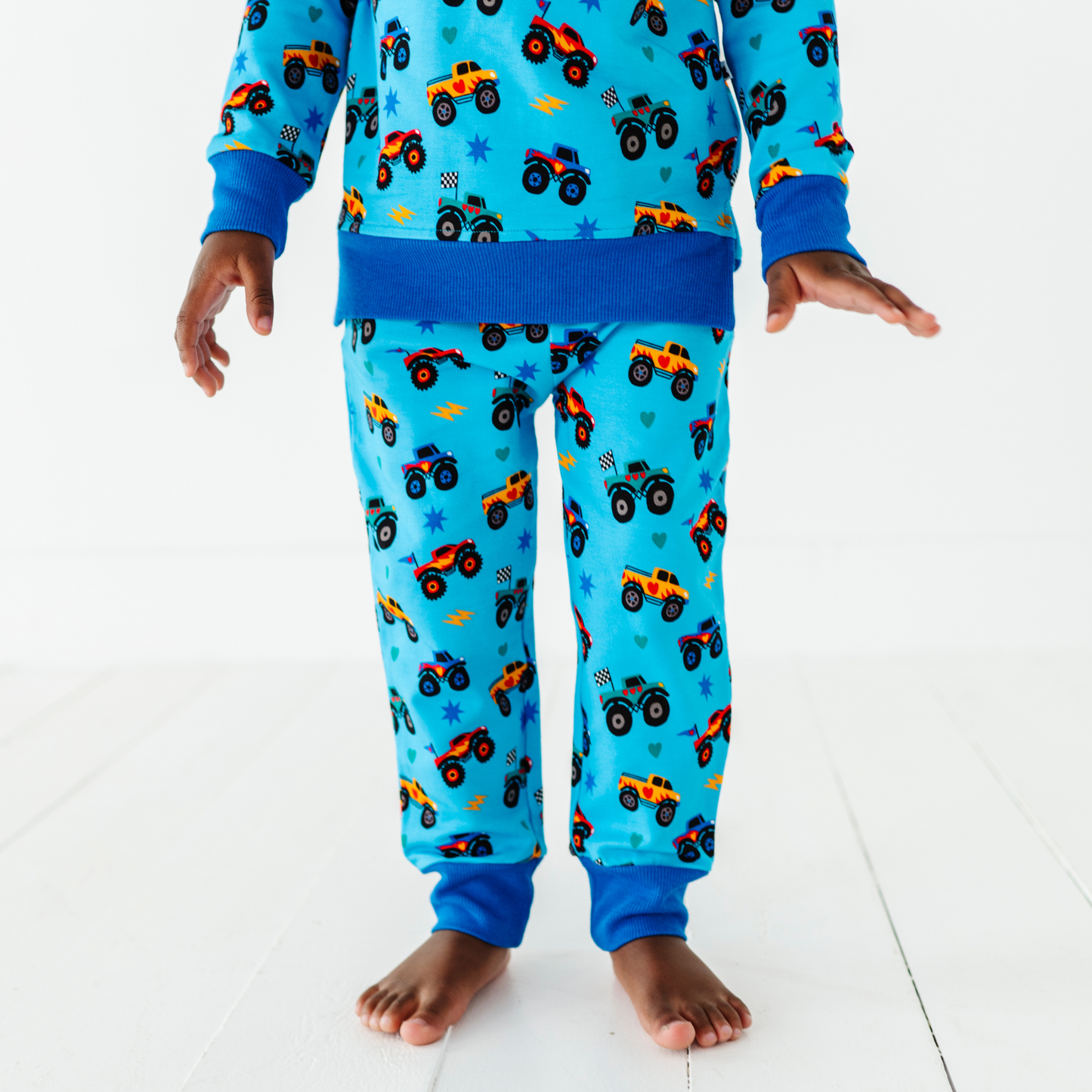 Kid wearing monster truck jogger set by Kiki and Lulu