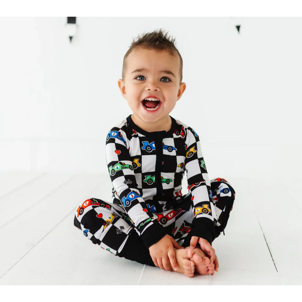 Kid in Racecar checkered footies by Kiki and Lulu