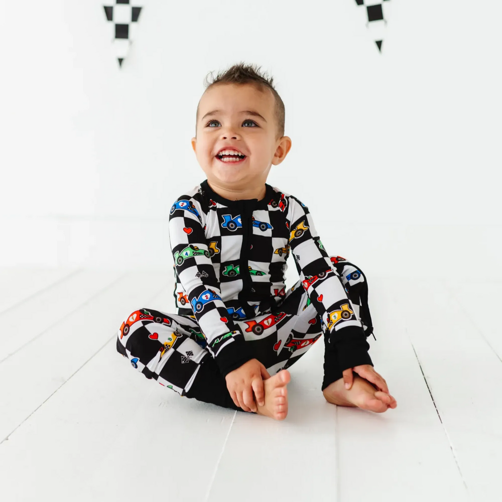 
                      
                        Kid in Racecar checkered footies by Kiki and Lulu
                      
                    