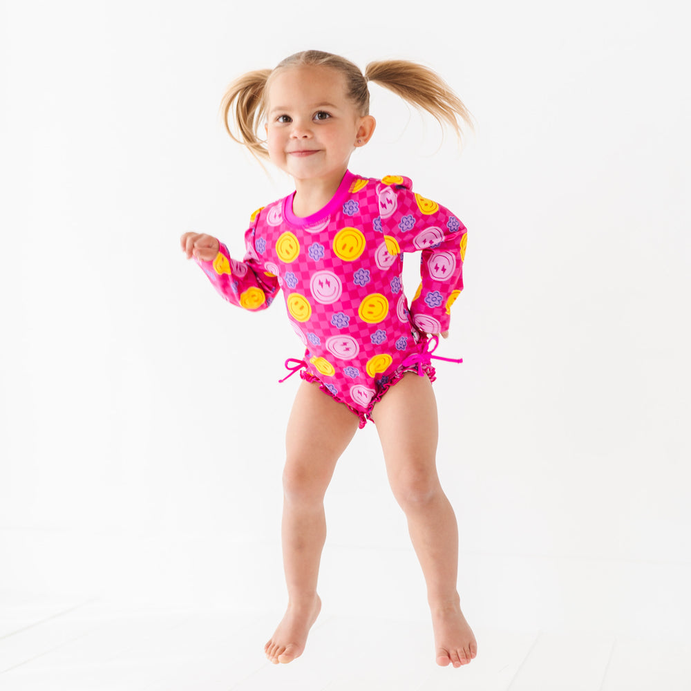 
                      
                        Electric Smiles Long Sleeve Ruffle Swimsuit
                      
                    