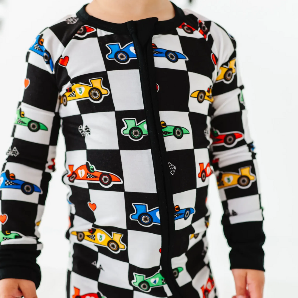 Kid in Racecar checkered footies by Kiki and Lulu