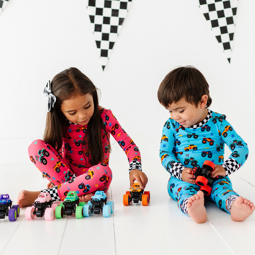 
                      
                        Brother and sister in sibling matching monster truck pajamas by Kiki and Lulu
                      
                    