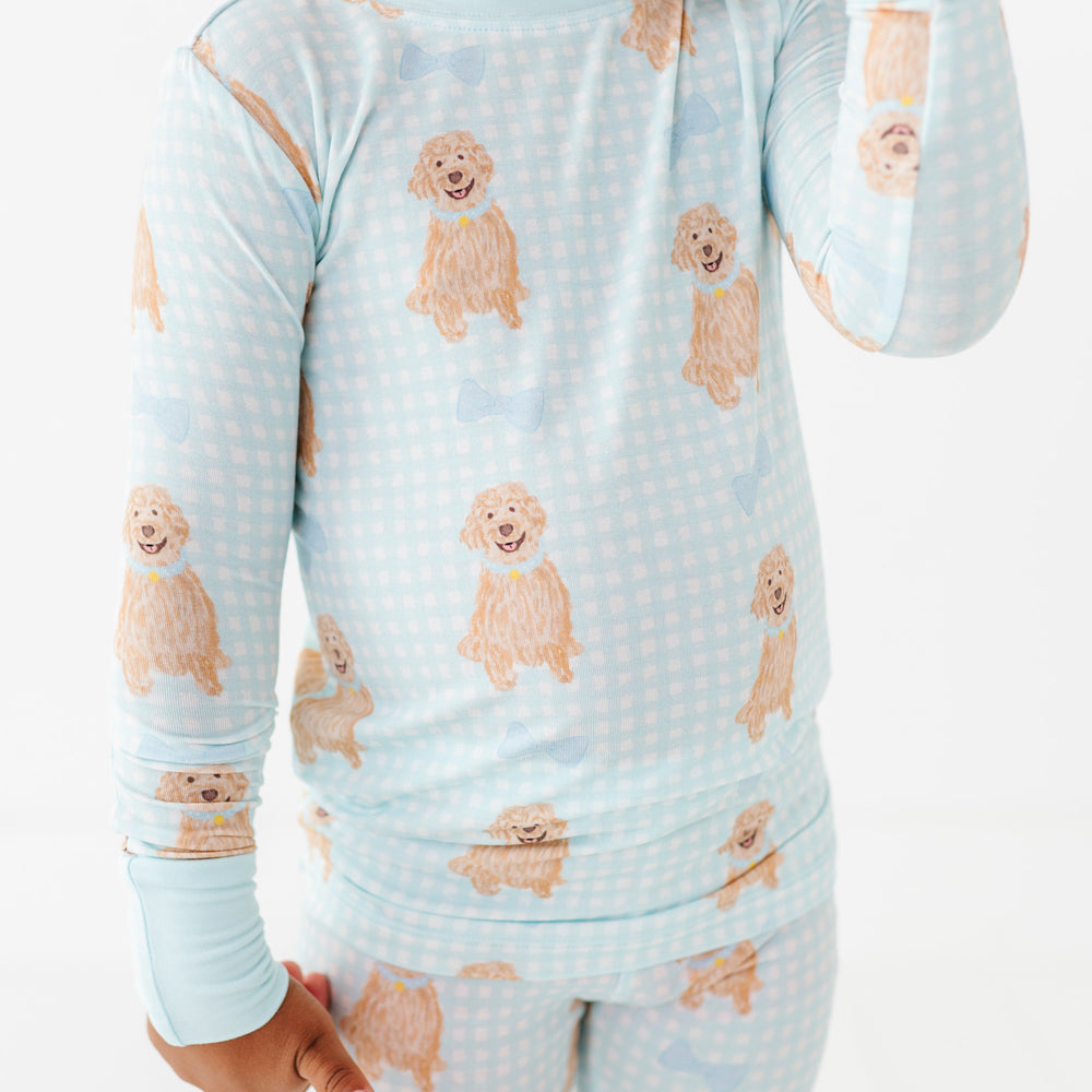 Child wearing pajamas with dog pattern on a white background