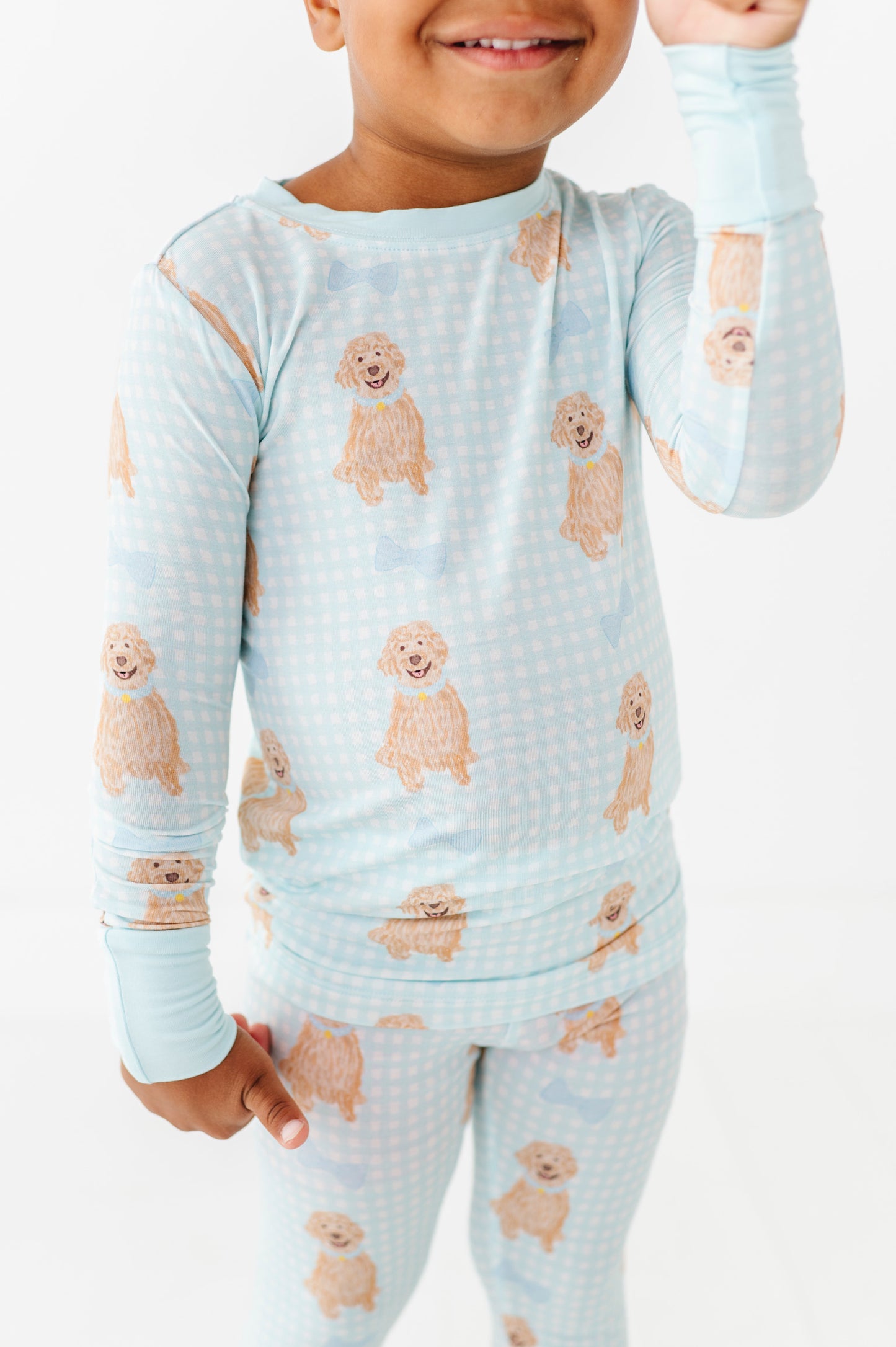 Child wearing pajamas with dog pattern on a white background
