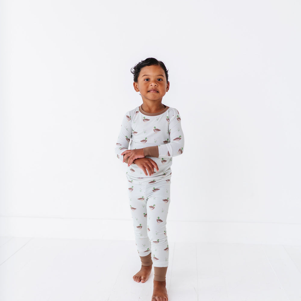 
                      
                        Child wearing a patterned pajama set on a white background
                      
                    