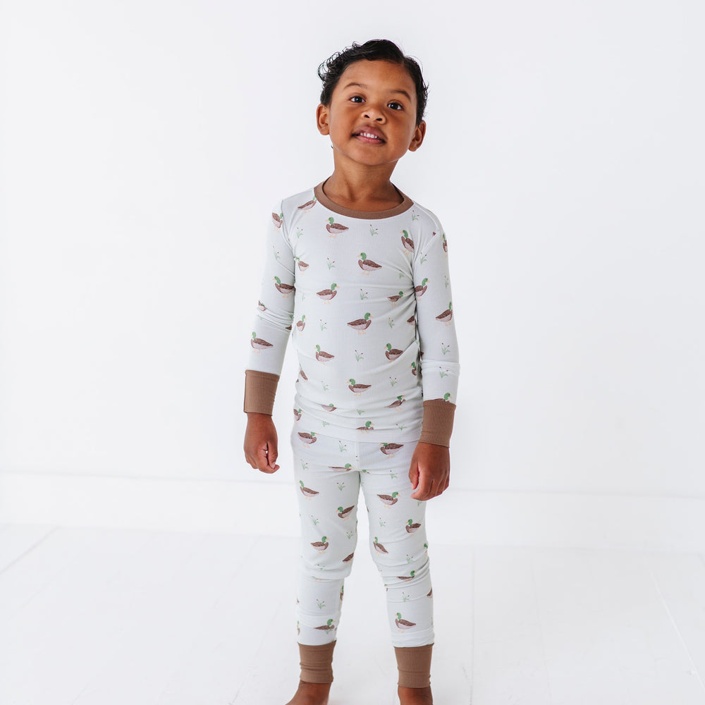 
                      
                        Child wearing a white long-sleeve shirt and pants with small prints on a white background
                      
                    