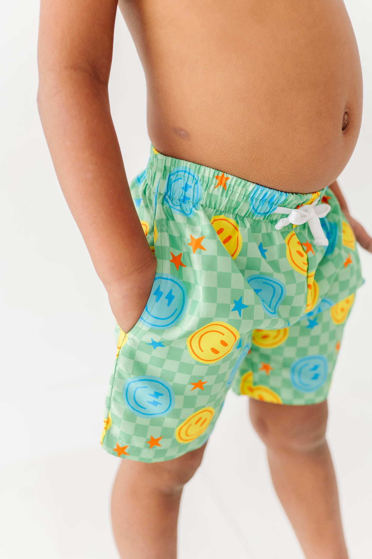 Boy in Neon Smiley Swim Trunks