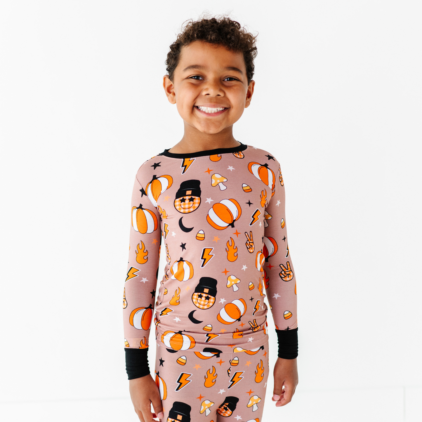 Boy wearing retro pumpkin pajamas by Kiki and Lulu