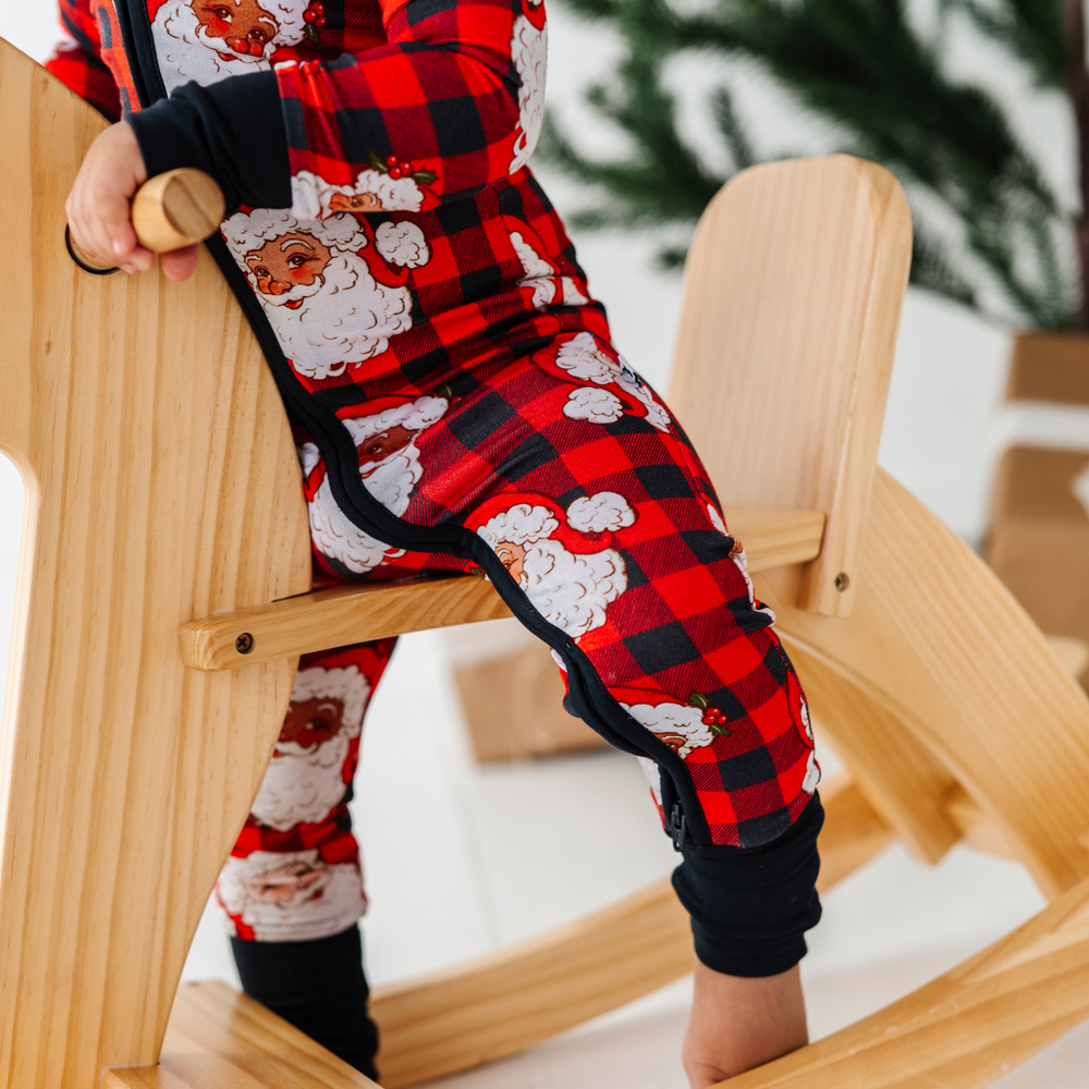 
                      
                        Baby in buffalo check santa pajamas by Kiki and Lulu
                      
                    