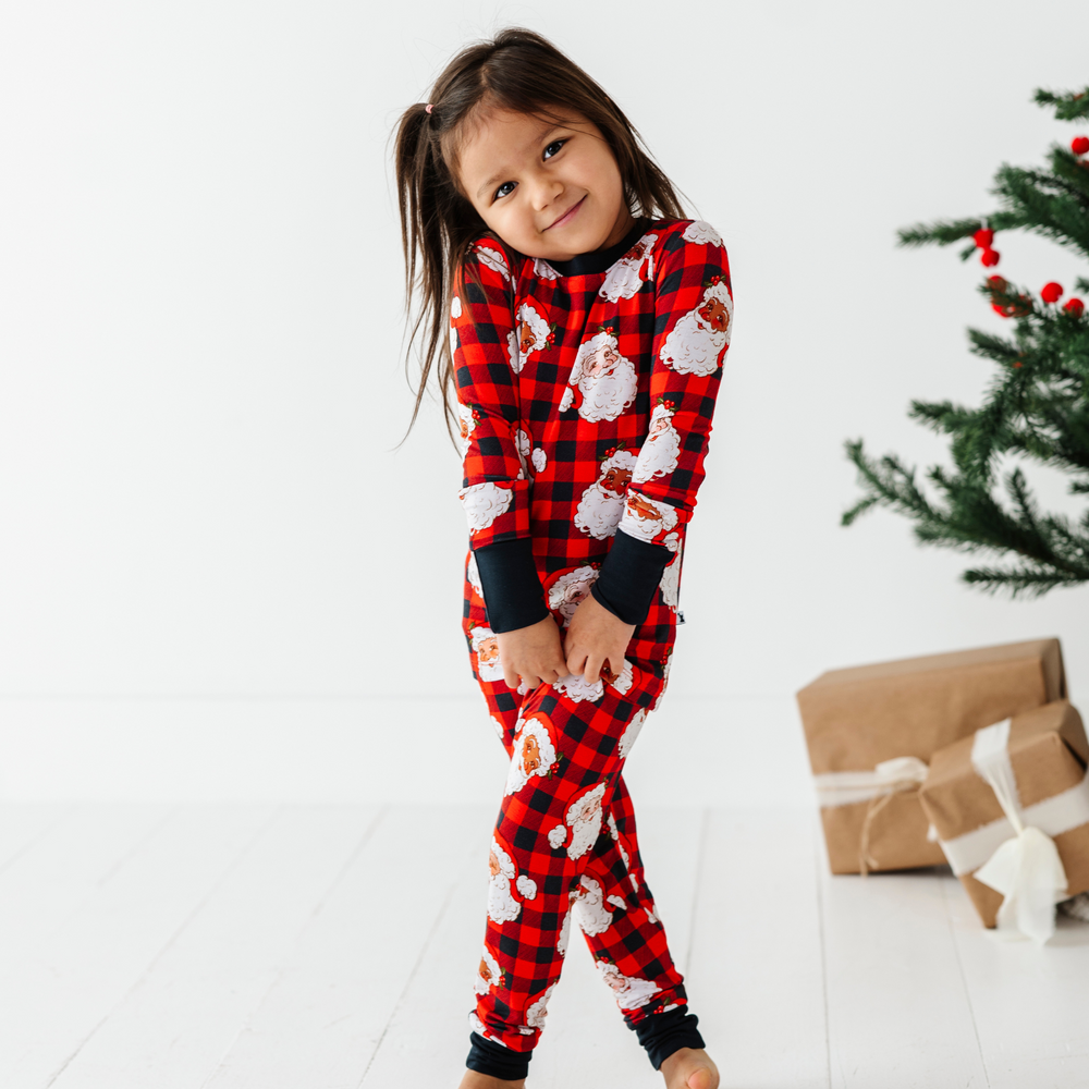 Girl in Buffalo Plaid Santa pajamas by kiki and lulu