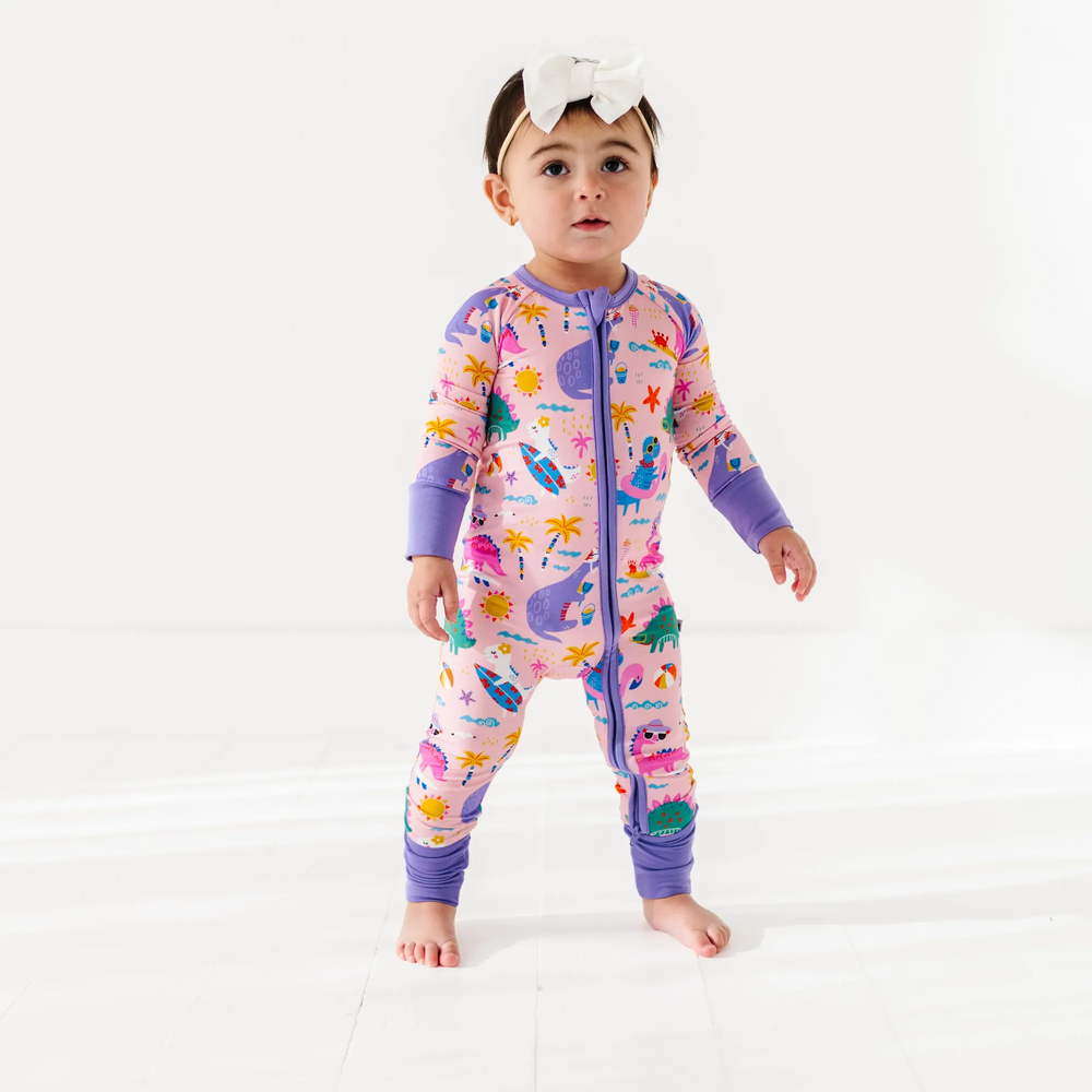 
                      
                        Baby Girl in dinosaur pajamas by Kiki and Lulu
                      
                    