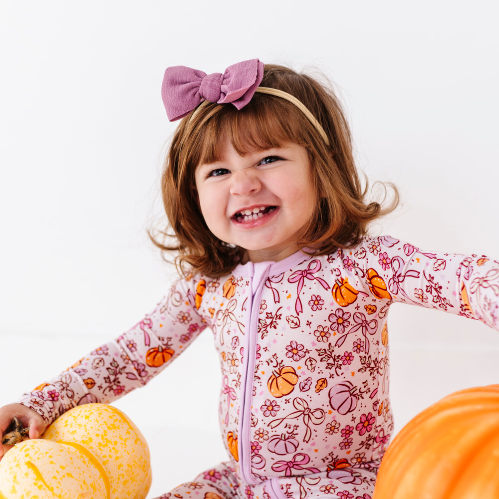 
                      
                        Girl in Purple Pumpkin and Bow Footies by Kiki and Lulu
                      
                    