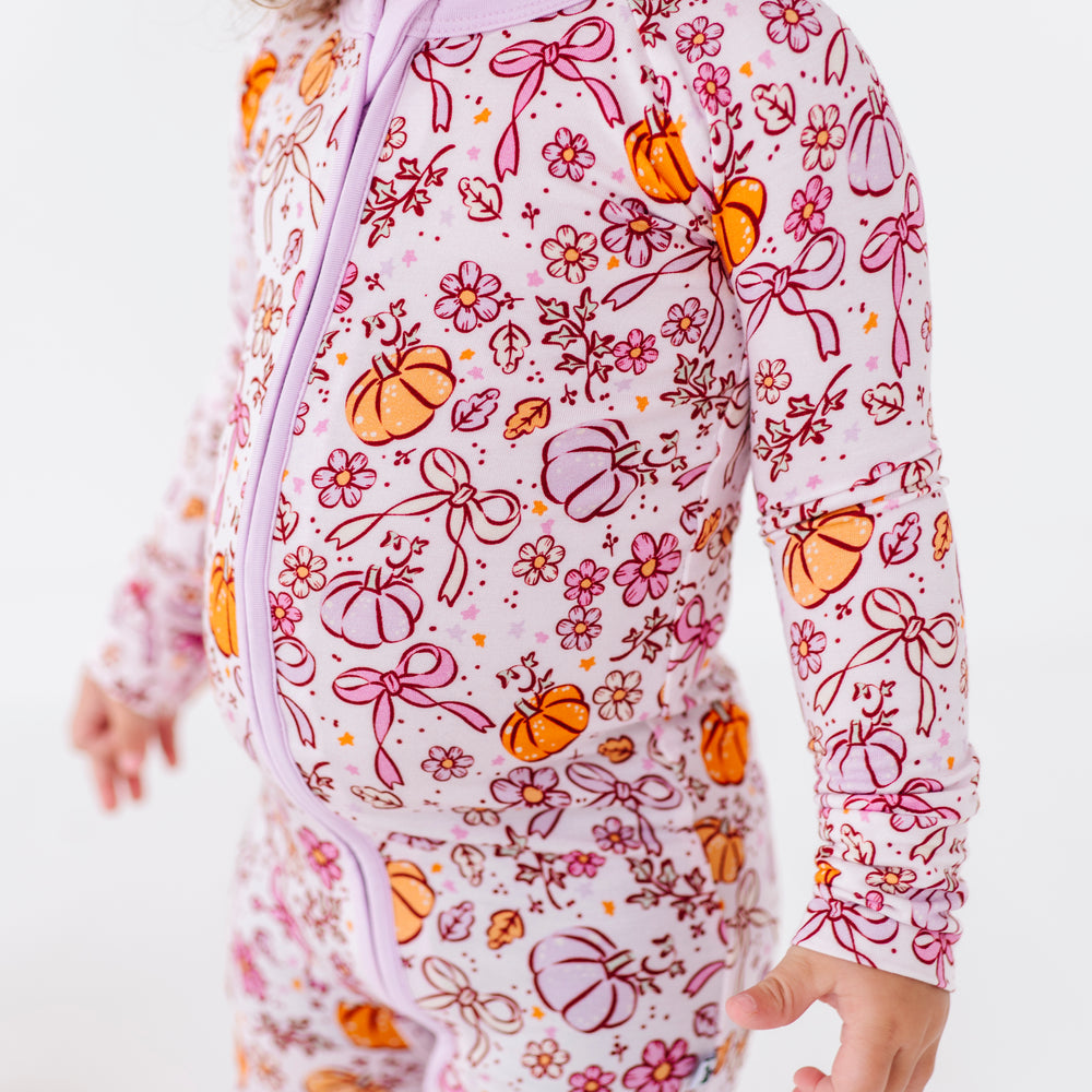 Girl in Purple Pumpkin and Bow Pajamas