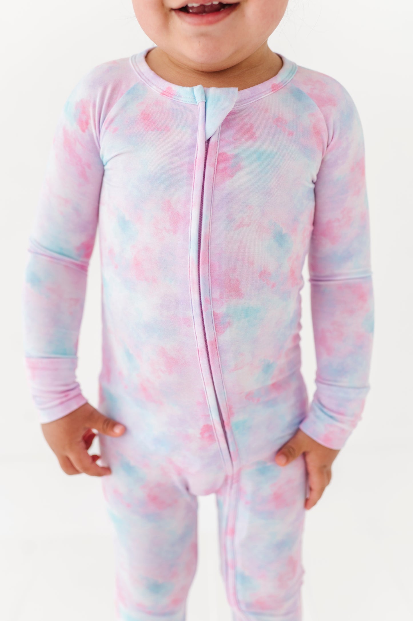 Girl in tie dye convertible footies by Kiki and Lulu