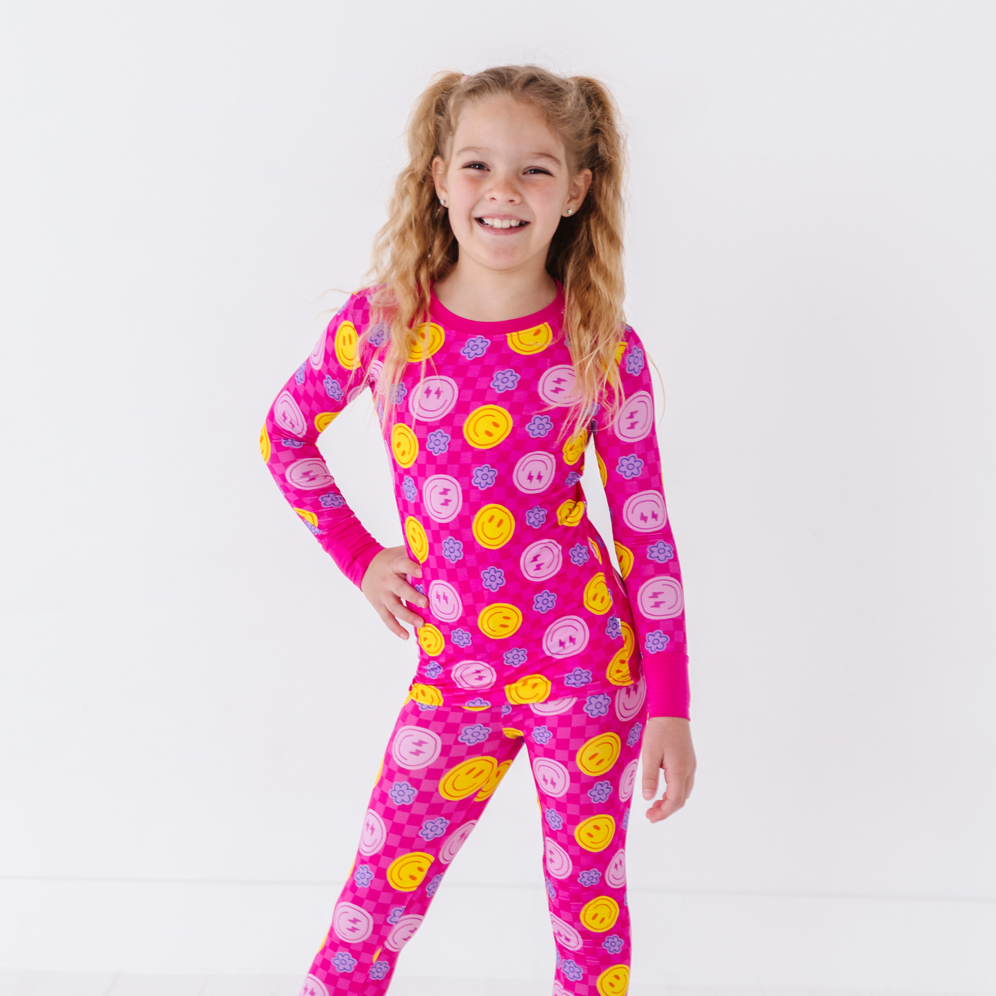 Girl wearing neon smiley pajamas