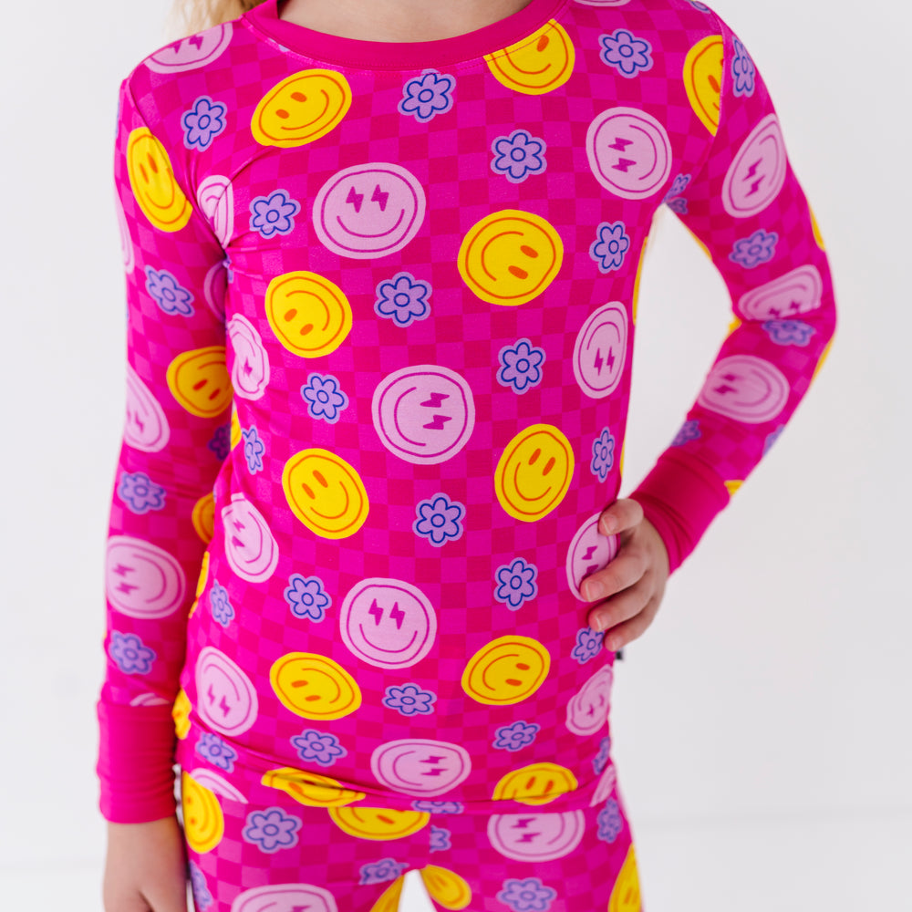 Girl wearing neon smiley pajamas By Kiki Lulu