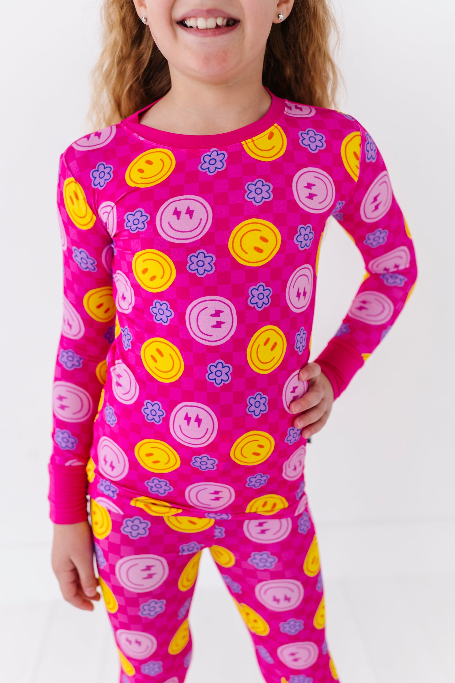 Girl wearing neon smiley pajamas By Kiki Lulu