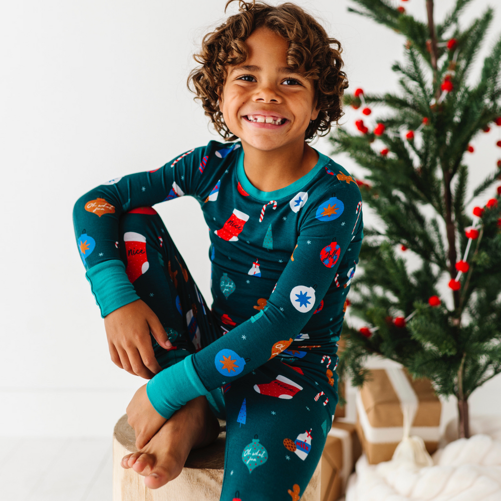 Boy in Green Christmas pajamas by Kiki and Lulu