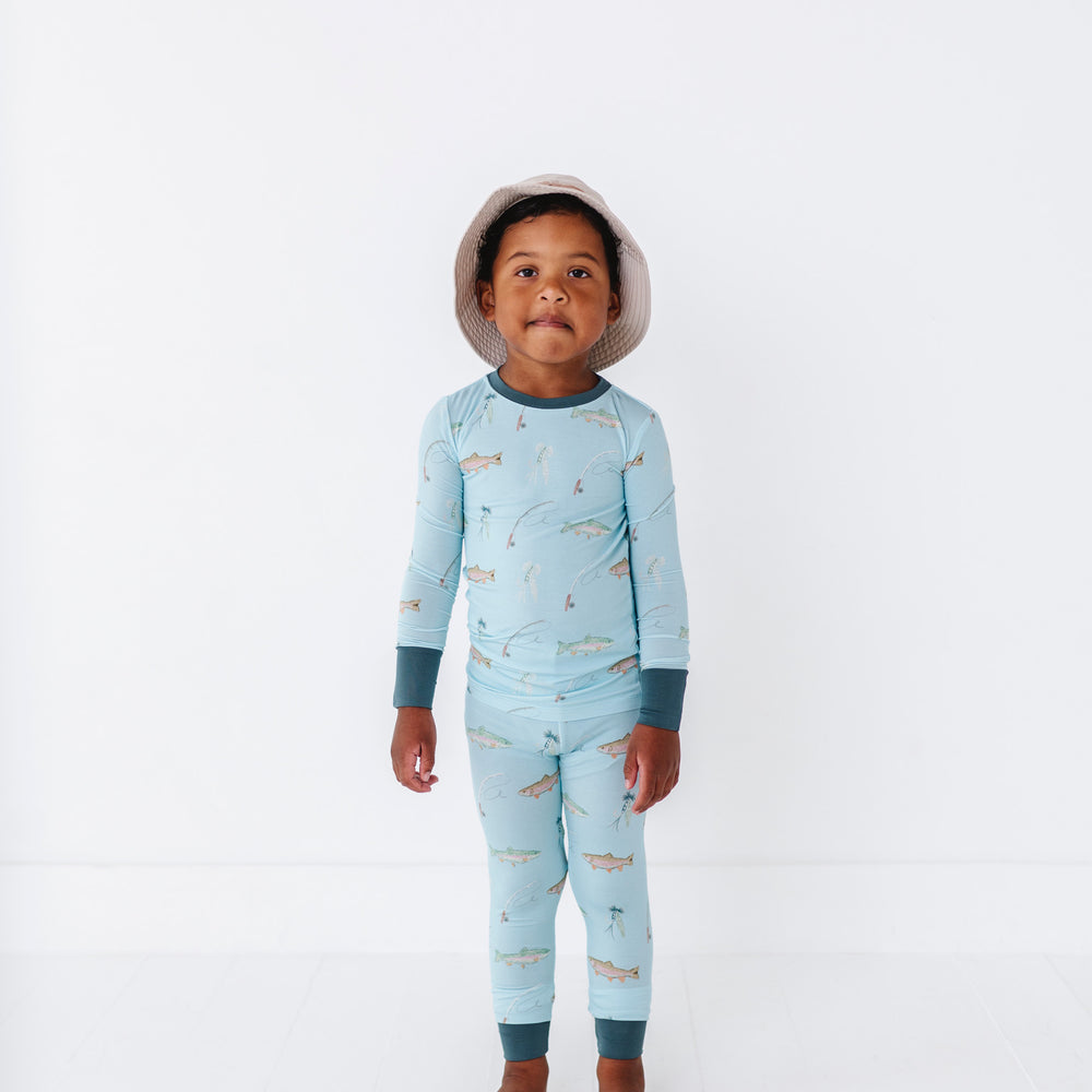 
                      
                        Child wearing a light blue onesie with fish pattern on a white background
                      
                    