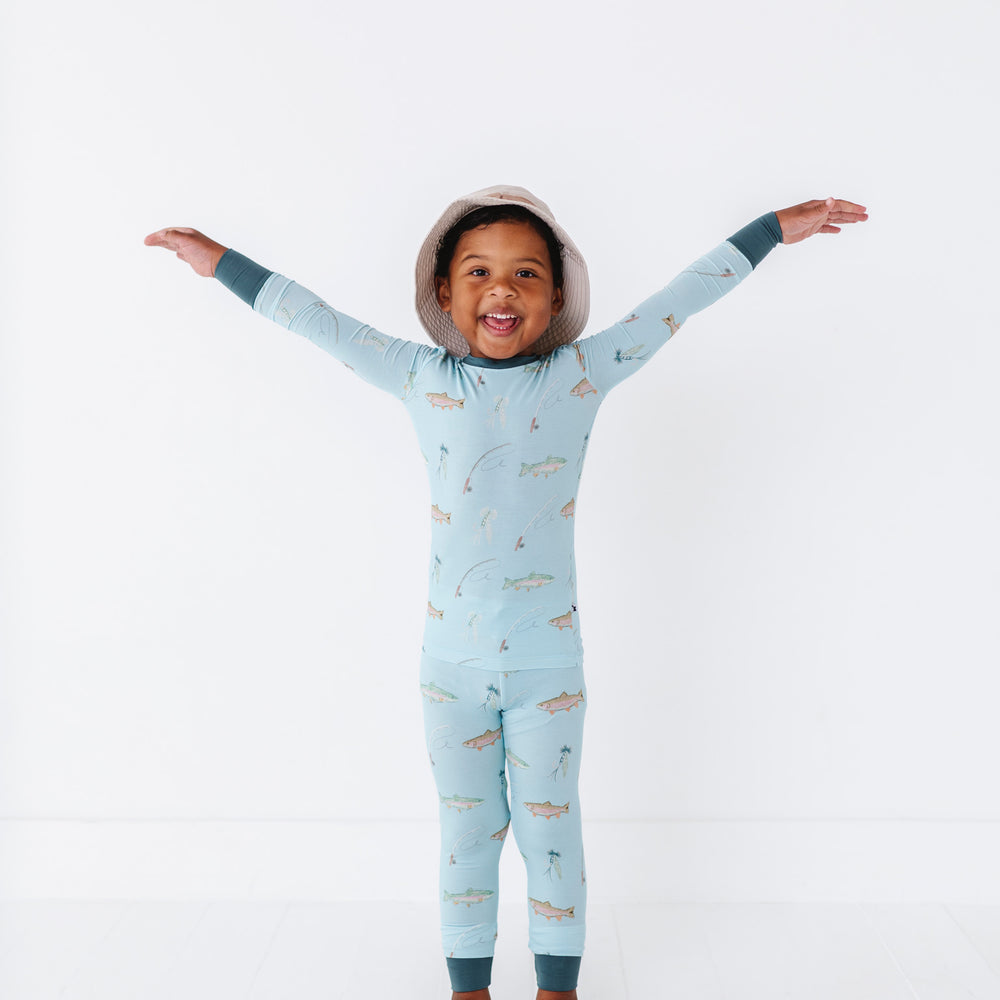 
                      
                        Child wearing a light blue onesie with animal prints on a white background
                      
                    