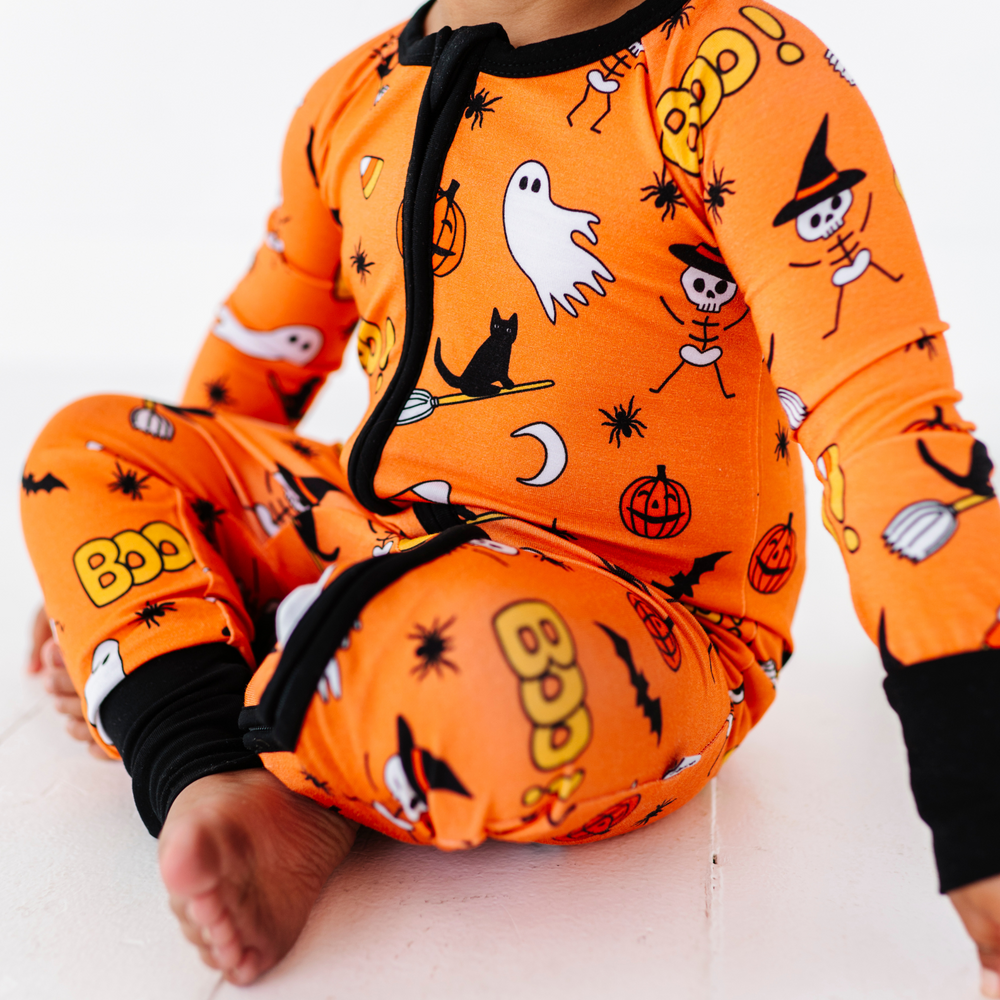 
                      
                        Girl in orange Halloween pajamas by Kiki and Lulu
                      
                    