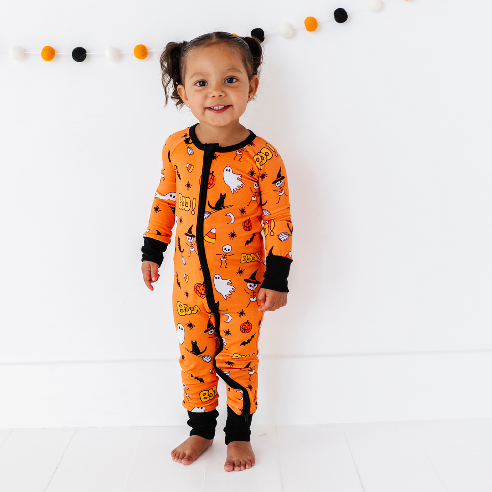 
                      
                        Girl in orange Halloween pajamas by Kiki and Lulu
                      
                    