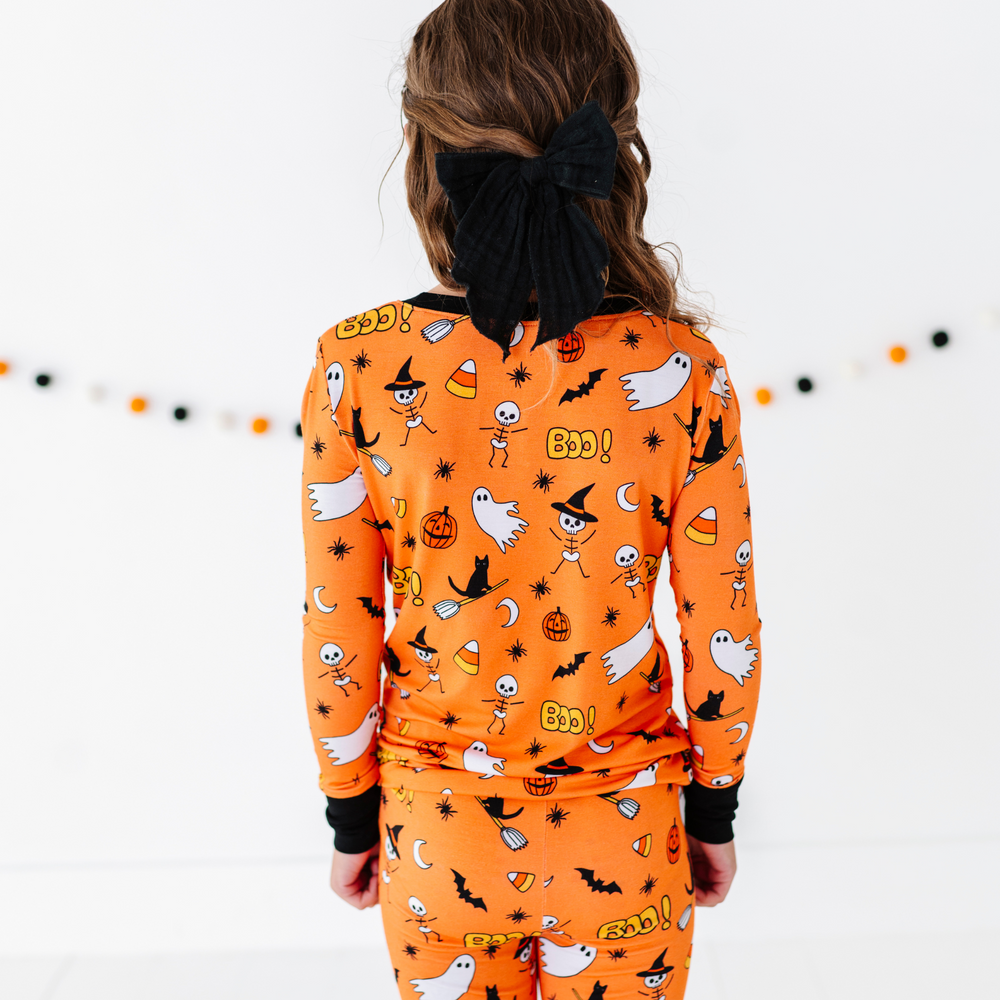 
                      
                        Girl in orange Halloween Pajamas
                      
                    