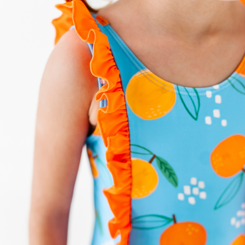 
                      
                        Be My Clementine Girls Swimsuit With Ruffle
                      
                    