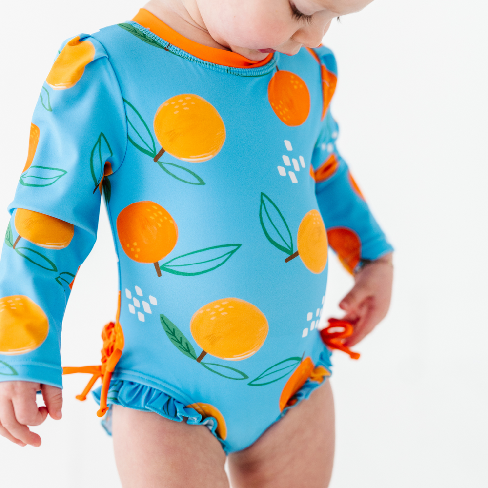 
                      
                        Be My Clementine Long Sleeve Ruffle Swimsuit
                      
                    