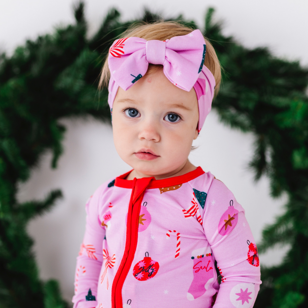 Baby in pink Christmas bow 