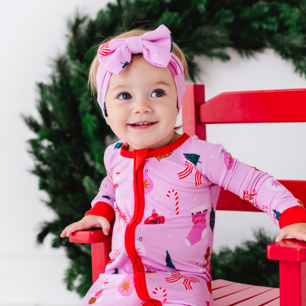 
                      
                        Baby in pink Christmas bow 
                      
                    