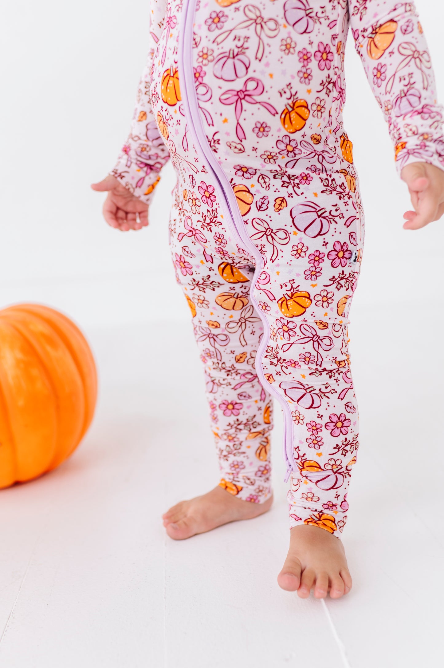 Girl in Purple Pumpkin and Bow Pajamas