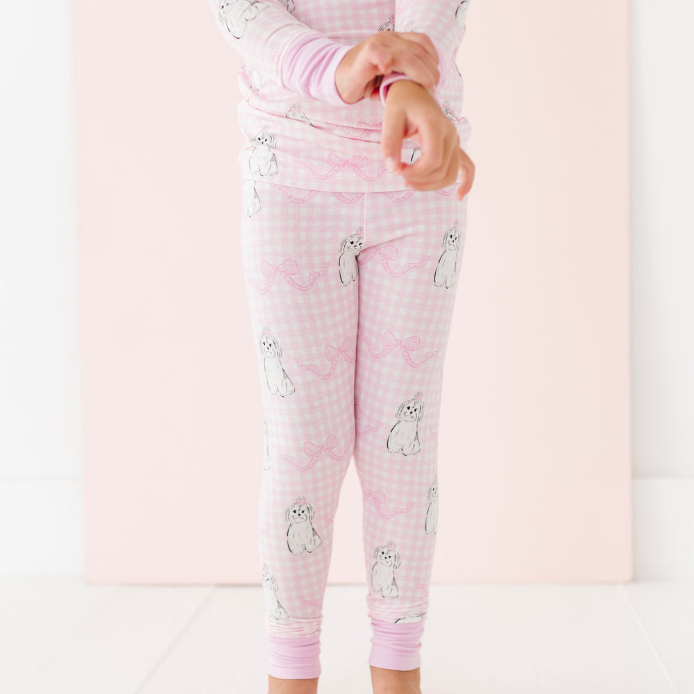 
                      
                        Child wearing pink pajamas with animal prints on a white background
                      
                    